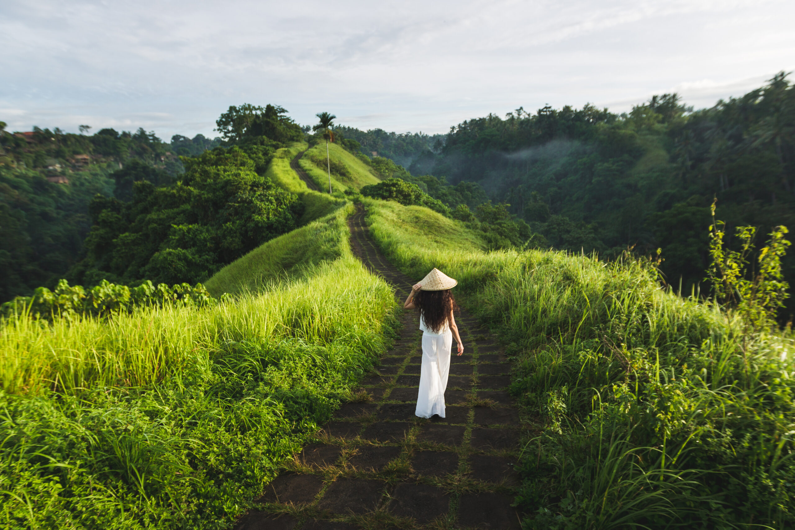 Young beautiful woman walking on Campuhan Ridge way of artists,